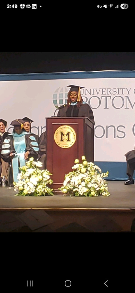 Dr. Geanie Asante delivering the commencement address at the University of the Potomac